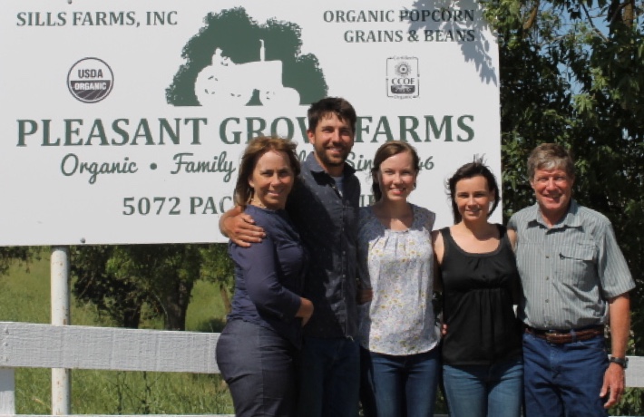 The Sills family in front of the Pleasant Grove Farms sign
